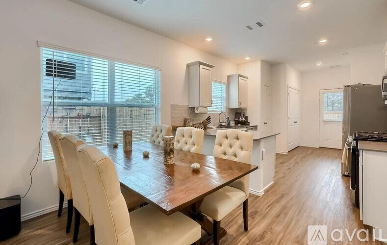 A modern kitchen with a dining table set for four.