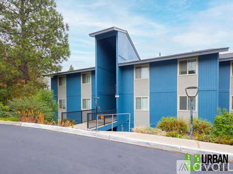 A blue building with a black fence in front of it.