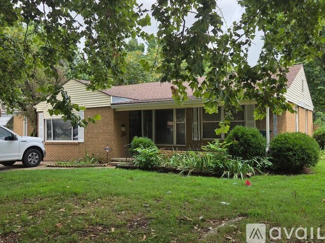 A house with a white car parked in front.