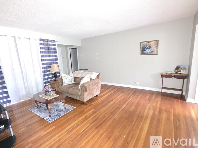 A living room with a couch, chair, and coffee table.