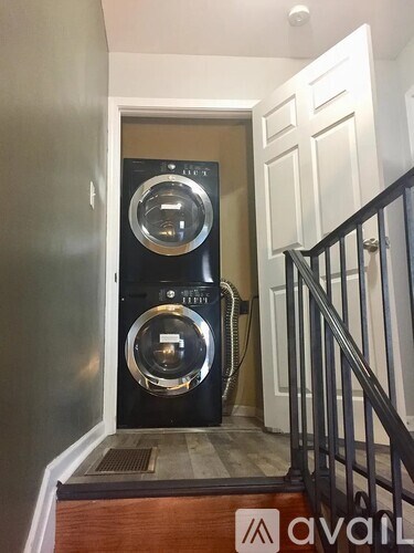 A washer and dryer are stacked on top of each other in a small space.