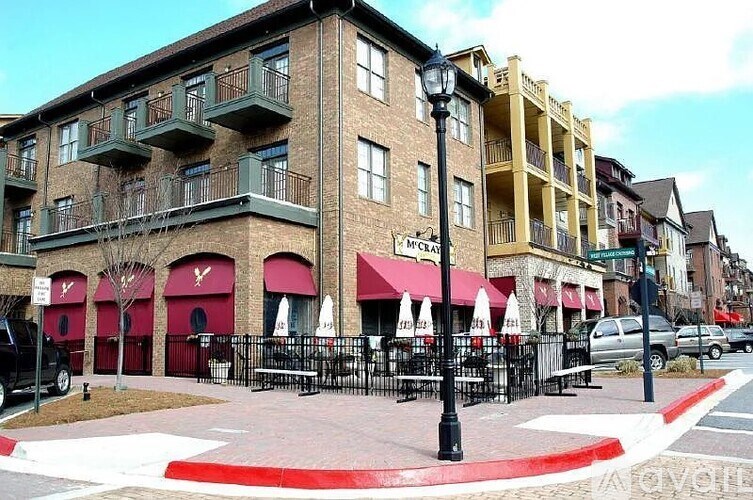 A street view of a city with buildings, cars, and a pedestrian crossing.