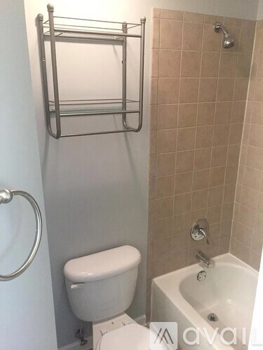 A white toilet sits next to a white sink in a bathroom.