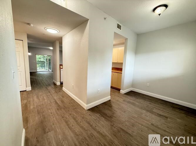 A room with wooden flooring and white walls is available for rent.