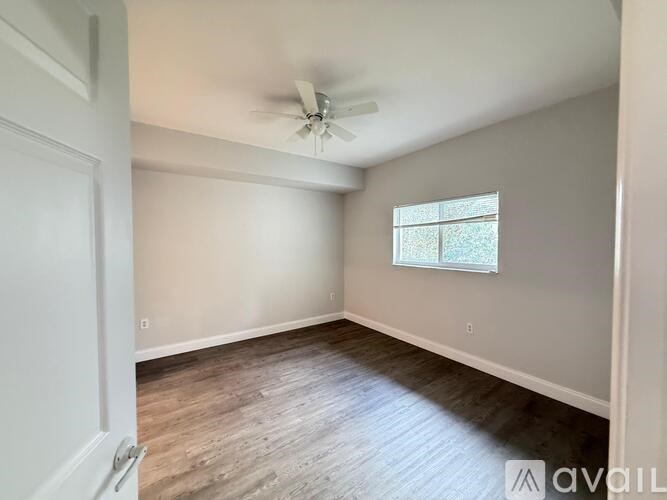A room with a window and a ceiling fan.