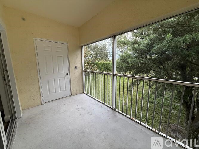 A balcony with a white door and a metal railing.