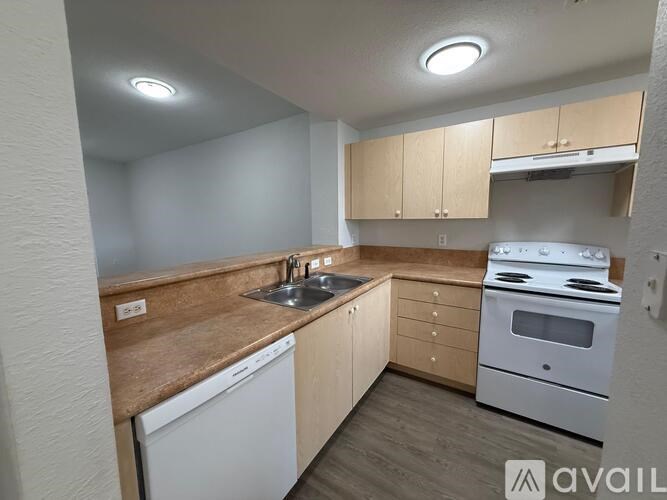 A kitchen with wooden countertops and white appliances.