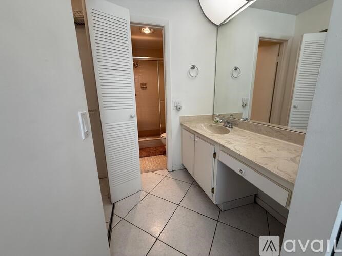 A bathroom with a sink, mirror, and toilet.