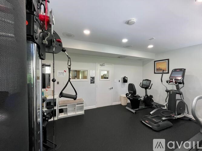 A gym room with a variety of exercise equipment.