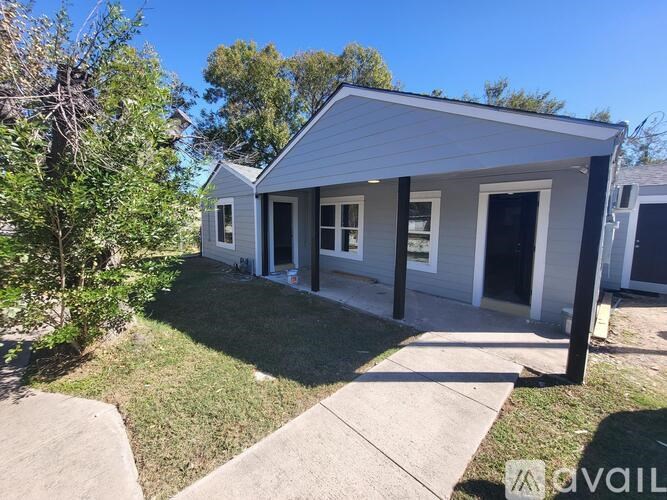 A small house with a porch and a covered entrance.
