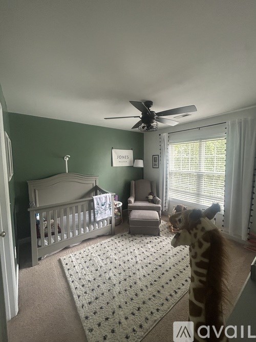 A baby room with a crib and a teddy bear.