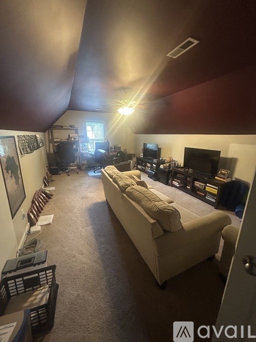 A living room with a couch and a television.