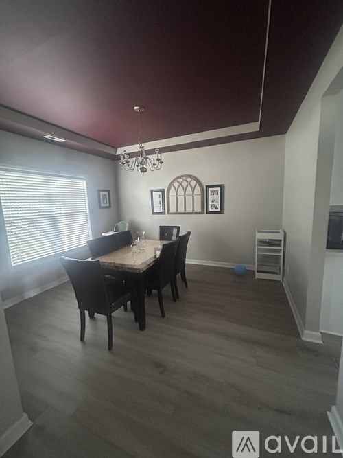 A dining room with a table set for four.