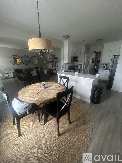 A kitchen with a table and chairs in the middle of the room.