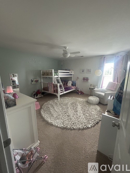 A bedroom with a bunk bed and a dresser.