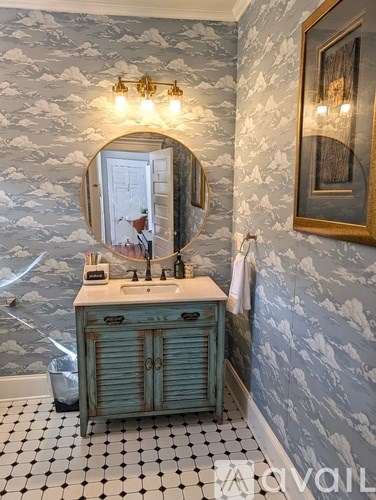 A bathroom with a sink and mirror.