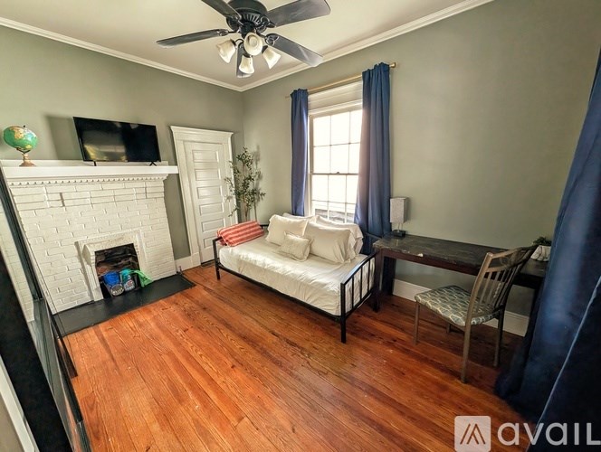 A living room with a fireplace, a sofa, and a chair.