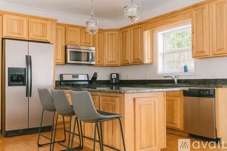 A kitchen with wooden cabinets and a black countertop.