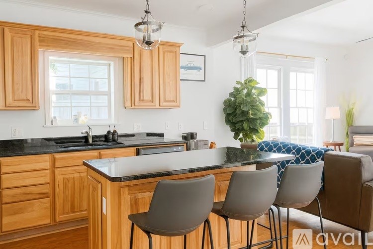 A kitchen with wooden cabinets and a black countertop.