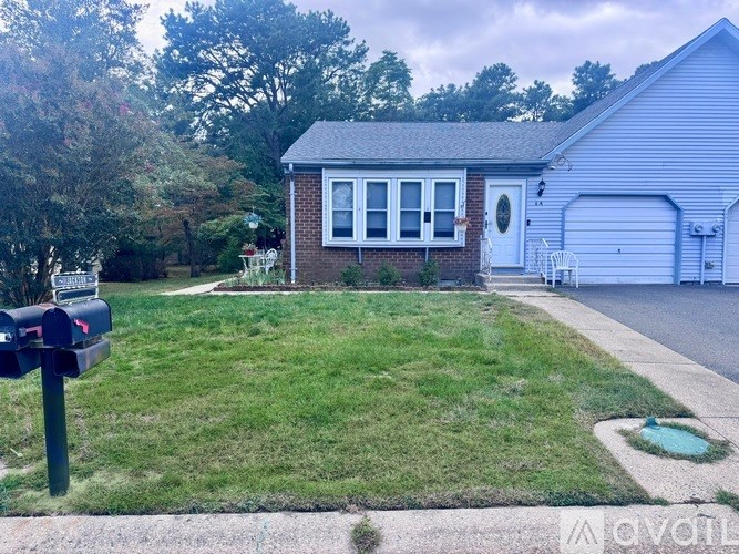 A house with a white garage door and a brick exterior.