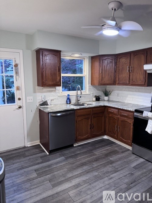 A kitchen with wooden cabinets and a white countertop.