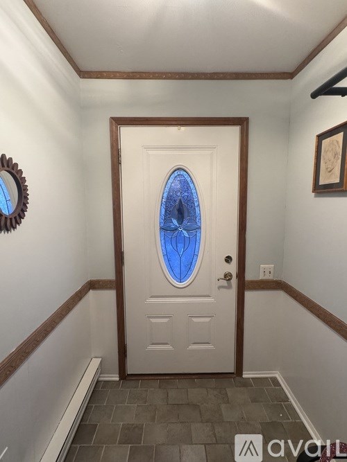 A white door with a blue window in the middle of it.