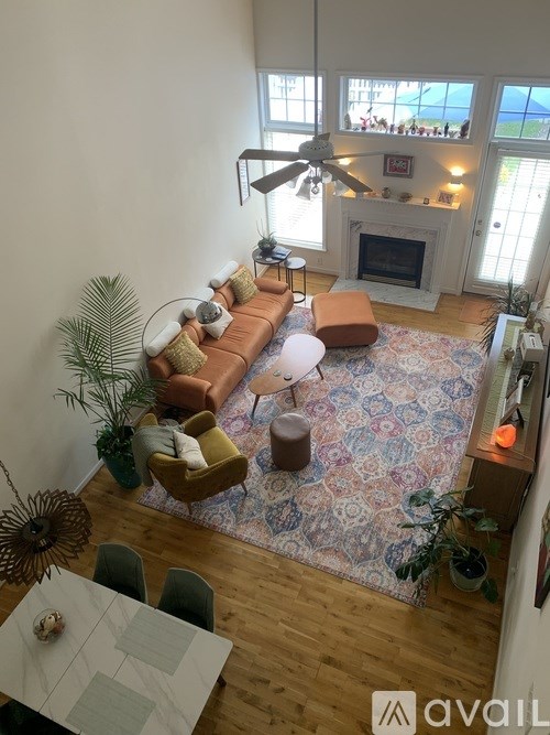 A living room with a fireplace and a rug.