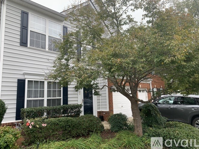 A house with a tree in front of it.
