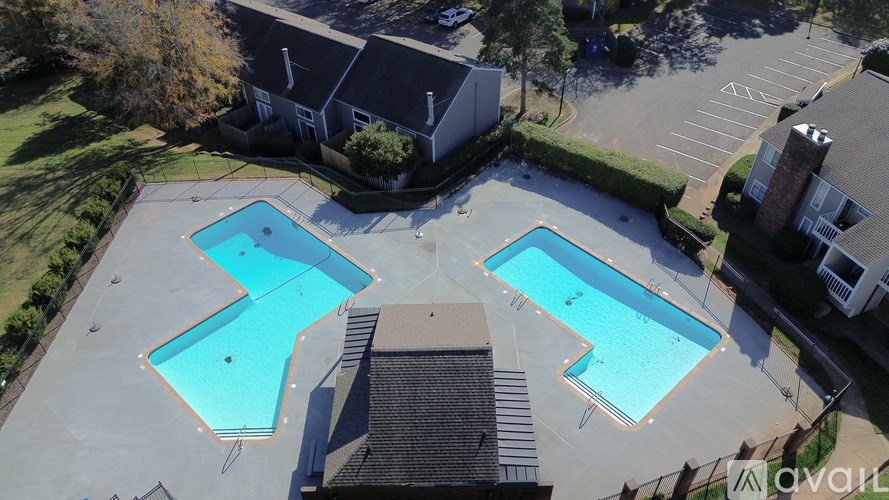 An aerial view of a swimming pool surrounded by buildings.