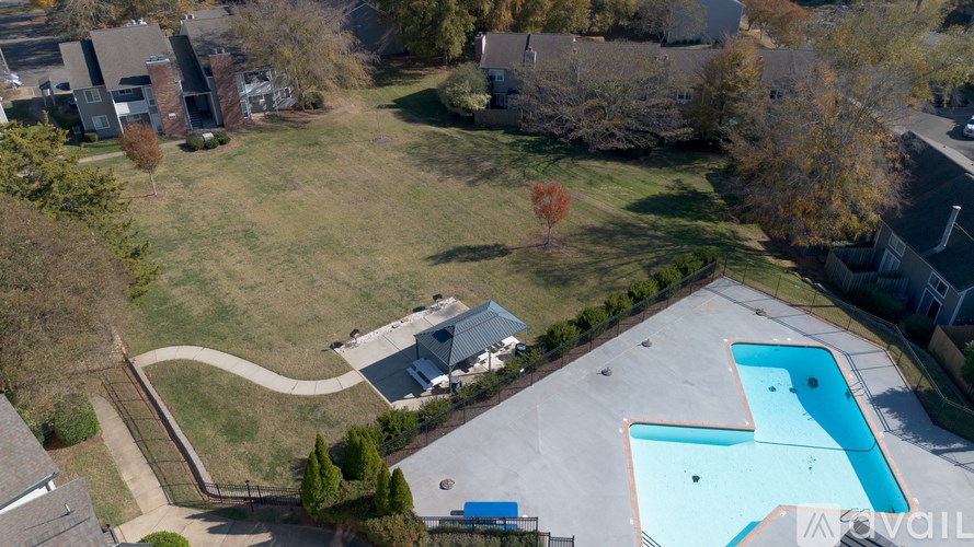 A swimming pool in a backyard surrounded by a fence.