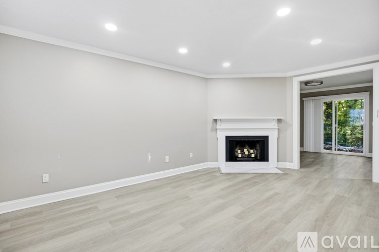 A spacious living room with a fireplace and sliding glass doors.