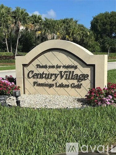 A sign for Century Village Flamingo Lakes Golf.