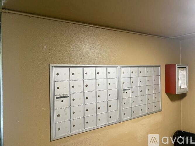 A wall-mounted mailbox with a red mailbox on the right.