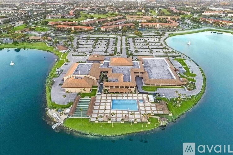 A bird's eye view of a resort with a large building and a pool.