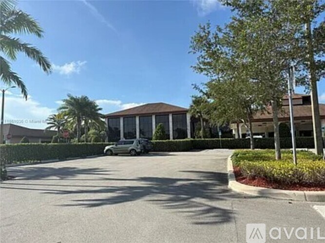 A building with a car parked in front of it.