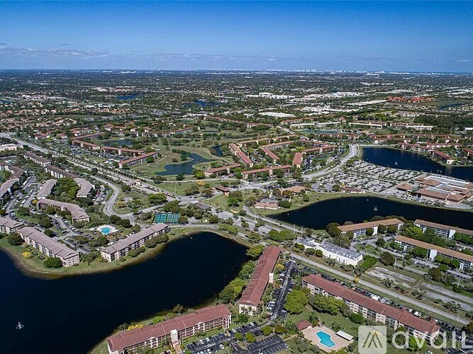 A bird's eye view of a residential area with a large lake in the foreground.