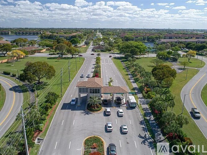 A busy street with cars and a building with the letters AVOIL on it.