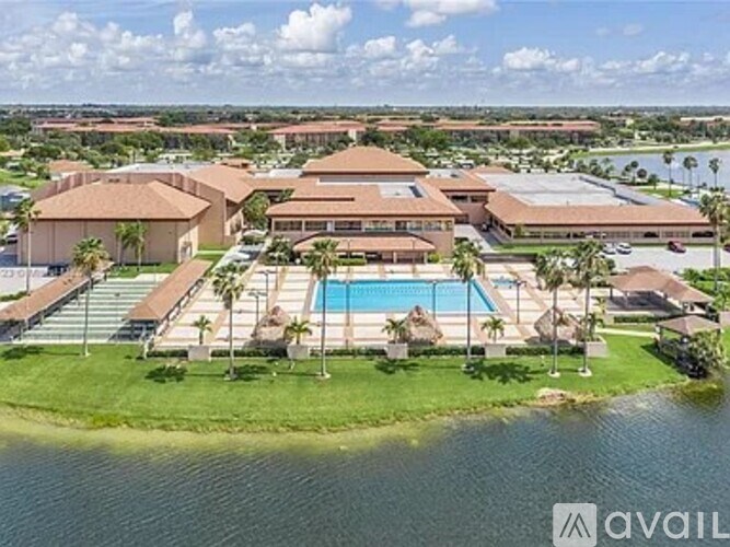 A large building with a pool in front of it.