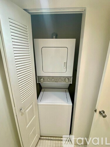 A white bathroom with a toilet and sink.