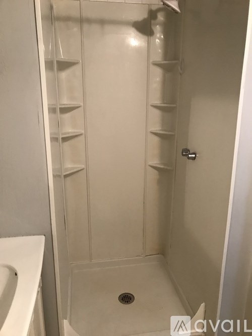 A white bathroom with a walk in shower.