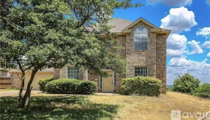 A house with a stone facade and a large front yard.
