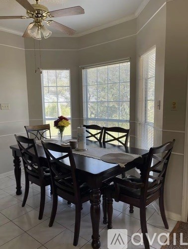 A dining room with a table set for six.