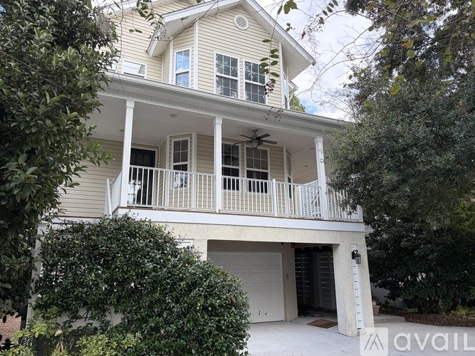 A two-story house with a balcony and a garage.