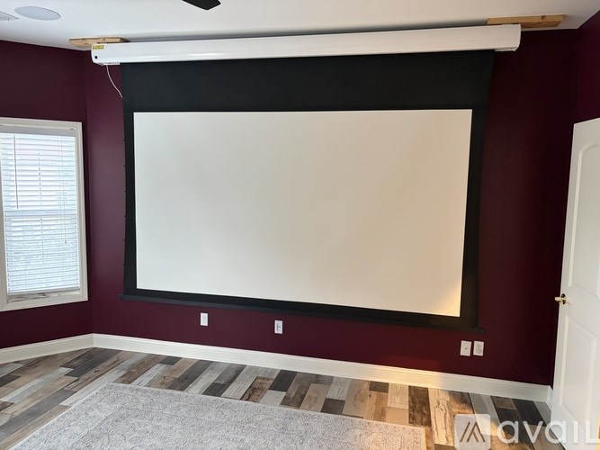 A room with a large white screen on the wall.