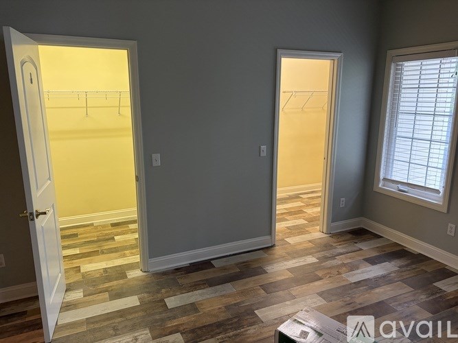 A room with two open doors and a window.