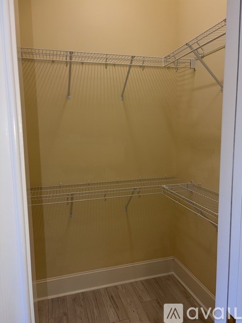 A walk-in closet with a white door and shelves.