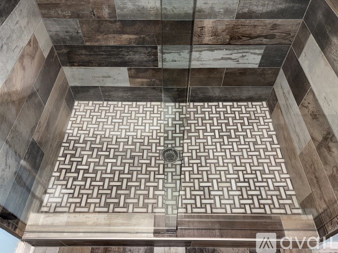 A square tile mosaic with a circular pattern in the middle.