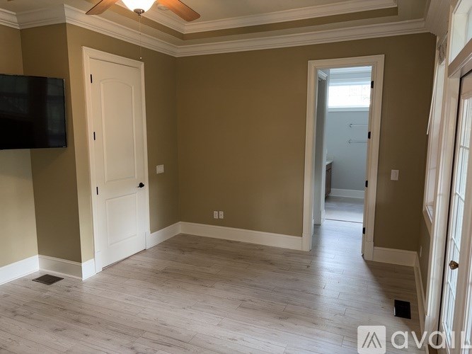 A room with a brown wall and a white door.