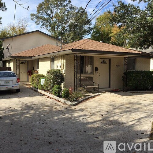 A house with a car parked in front of it.