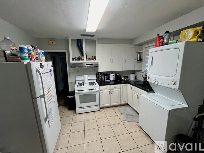 A kitchen with white appliances and a white refrigerator.